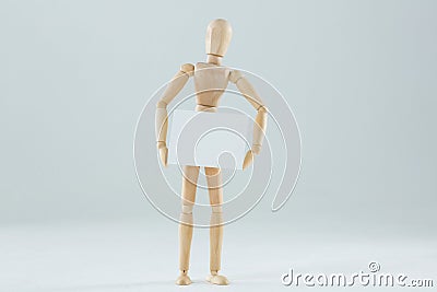 Wooden figurine holding blank placard Stock Photo