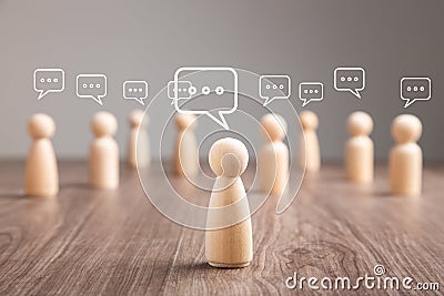 Wooden figurine with speech bubble. Mingle, discussion, chatting concept Stock Photo