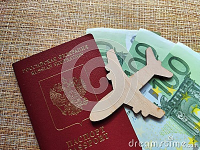 Wooden figurines, Russian citizen passport, Euro banknotes. Concept of traveling and payment. Conflict between Russia Stock Photo