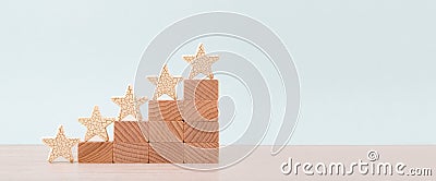 Wooden five star shape on table. Concept of increase rating, ranking, evaluation and classification idea Stock Photo