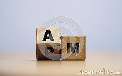 Wooden flipping change between AM and PM for shift from daytime and nighttime concept Stock Photo
