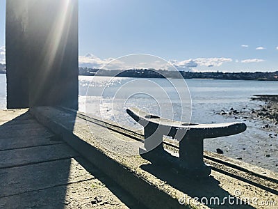 Wooden floating dock with mooring bitts under sunshine morning. Stock Photo