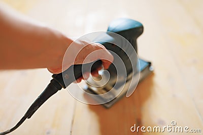 Wooden floor sanding with flat sander tool Stock Photo