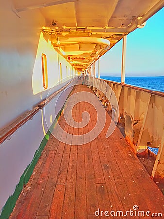 A wooden-floored passageway on a passenger ship sailing at sea Stock Photo