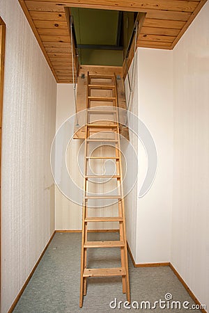 Wooden folding ladder to the attic, old empty house Stock Photo