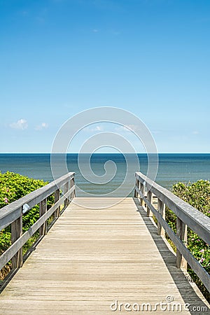 Wooden foot bridge leading towards the ocean Stock Photo