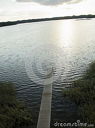 Wooden footbridge over the lake Stock Photo