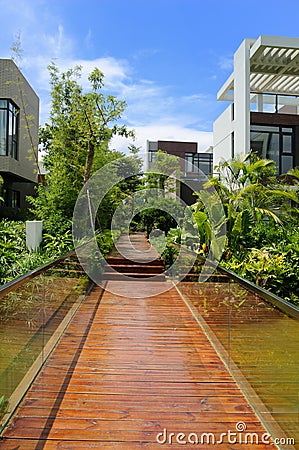 Wooden footpath through a tranquil garden Stock Photo