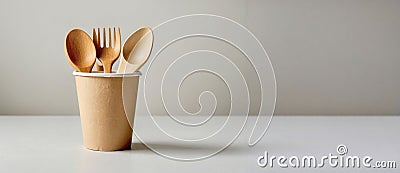 Wooden forks and spoons in paper cup. ecology, zero waste concept. copy space. Banner Stock Photo