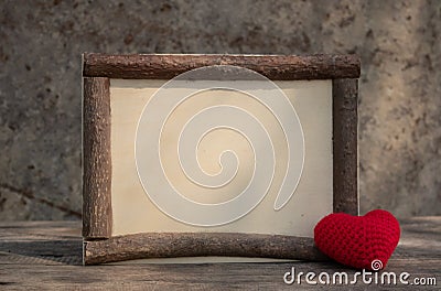 Vintage style wooden frame with heart on the wooden table Stock Photo