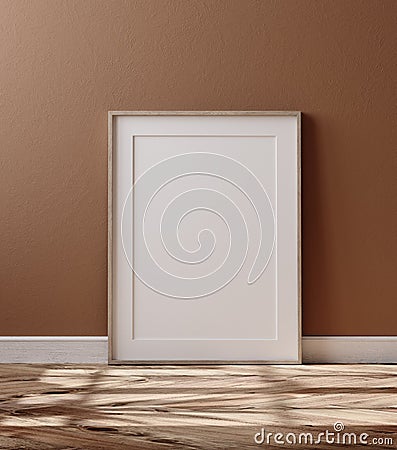 Wooden frame with poster mockup standing on floor Stock Photo