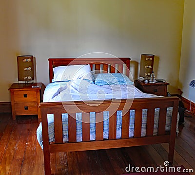 Wooden framed double bed in a quirky rental property in Masterton in New Zealand Editorial Stock Photo