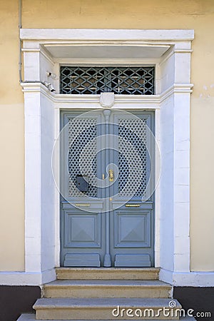 Wooden front door with metal grates Stock Photo