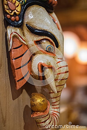 The Wooden of ganesha isolated on wooden background. Colorful Tradition wooden masks and handicrafts on sale at shop Stock Photo