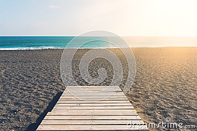 Wooden gangplank on beach against sea and blue sky Stock Photo