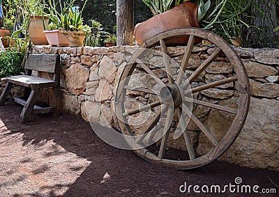 Wooden garden decors, bench and wheel Stock Photo