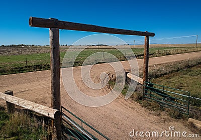 Wooden gate on dirt road Stock Photo