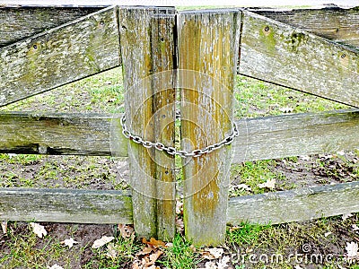 Wooden gates closed by the metal chain Stock Photo