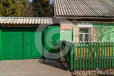 Wooden gates and a gate to the house-museum of the writer V.P. Astafiev with a memorial plaque at the entrance on a sunny spring Editorial Stock Photo