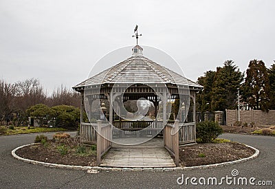 A Serene Wooden Gazebo with a Weathervane Stock Photo