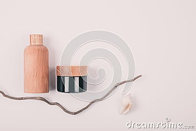 Wooden and glass bottles containers blank mockup for skincare cosmetic products on beige pastel background Stock Photo