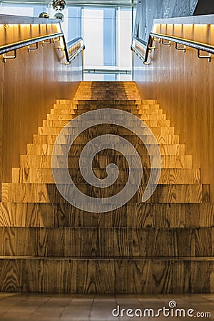 Wooden going up stairs with backlight inside a building Stock Photo