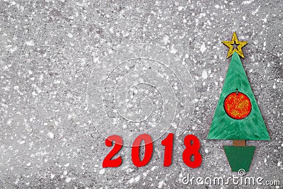 Wooden Green Christmas tree, sign 2018 from wooden red letters, gray concrete background. Happy new year 2018 backdrop. Greeting Stock Photo