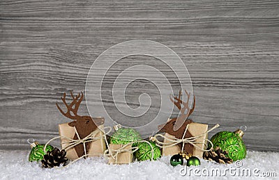 Wooden grey christmas background with reindeer, balls and gifts Stock Photo