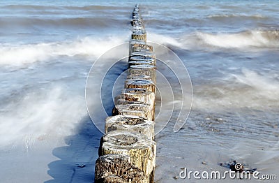 Wooden groynes as coast protection in the sea on a sunny day, sm Stock Photo