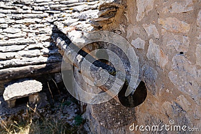 wooden gutter from the middle ages of a very old house drain pipe on restoration vintage medieval house Stock Photo