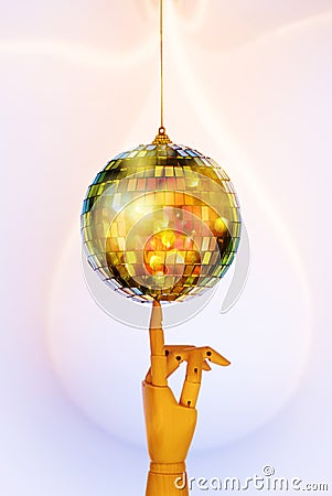 Wooden hand holding mirrored Disco ball. Minimalism party concept. Stock Photo