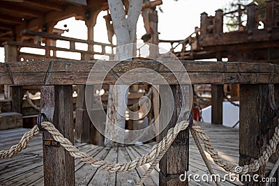 Wooden handrails with intertwined rope close up Stock Photo