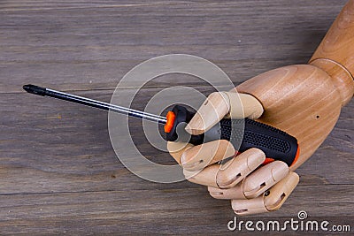 Wooden hands and screwdriver Stock Photo