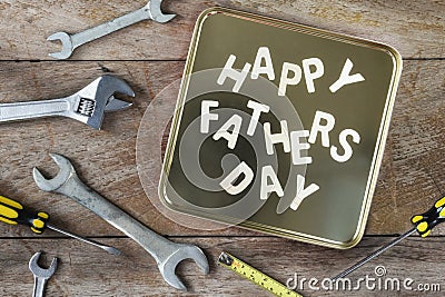 Wooden happy fathers day words with tools supplies Stock Photo