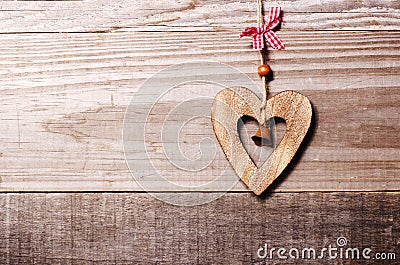 Wooden heart with bell decoration on vintage oak background, spa Stock Photo
