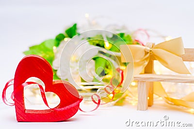 Wooden heart with a bow on a bench on a white background. Valentines Day. concept of love, romantic decor. Stock Photo