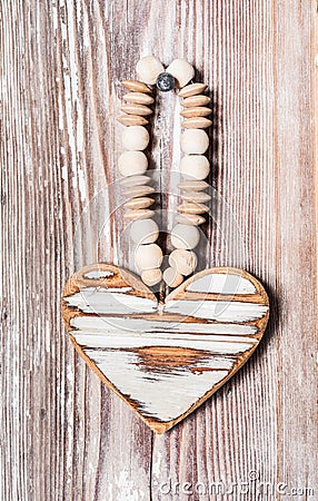 Wooden heart hanging on a rustic plank Stock Photo