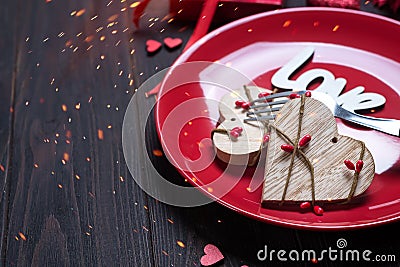 Wooden heart on red plate for valentine`s day with love concept for valentines day with sweet and romantic moment Stock Photo