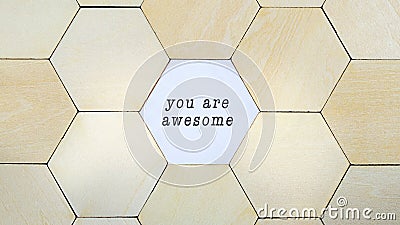 Hexagon missing from puzzle, revealing the words You Are Awesome in a conceptual image of personal growth and optimism Stock Photo