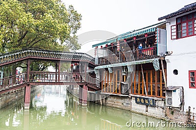 Wooden historic buildings at the bank of canal river in Zhujiajiao in a rainy day, an ancient water town in Shanghai, built during Editorial Stock Photo