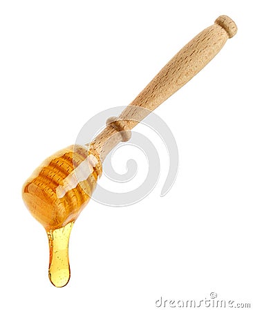 Wooden honey dipper with honey drop on white background Stock Photo