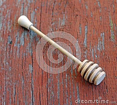 Wooden honey drizzler on wooden background Stock Photo