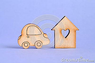 Wooden house with hole in the form of heart with car icon on purple background Stock Photo