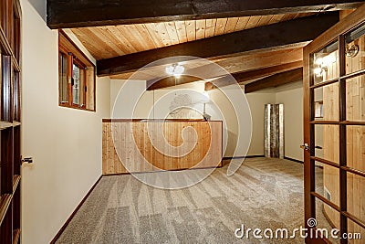 Wooden house interior with carpet floor , ceiling with wooden beams Stock Photo