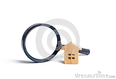 Wooden house and magnifying glass on a white background. Buying and selling real estate, building new buildings, offices and homes Stock Photo