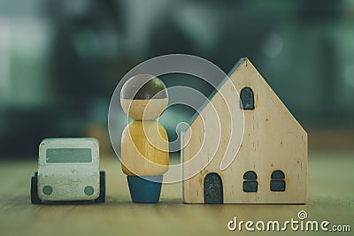 Wooden house model with car and figure of people. The concept of affordable housing and car Stock Photo