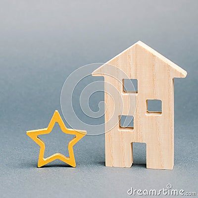 Wooden house and one star. Concept of negative feedback. Low quality and service serving. Evaluation of the critic. Hotel or Stock Photo