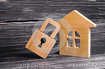 Wooden house with a padlock. House with a lock. Security and safety, collateral, loan for a mortgage. Confiscation of property Stock Photo