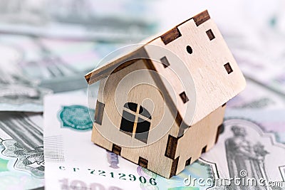 Wooden house symbol with money, russian rubles Stock Photo