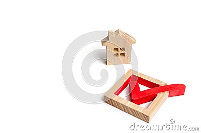 Wooden house and a tick in the box. concept of finding a home and moving to a new home. Standardization Stock Photo